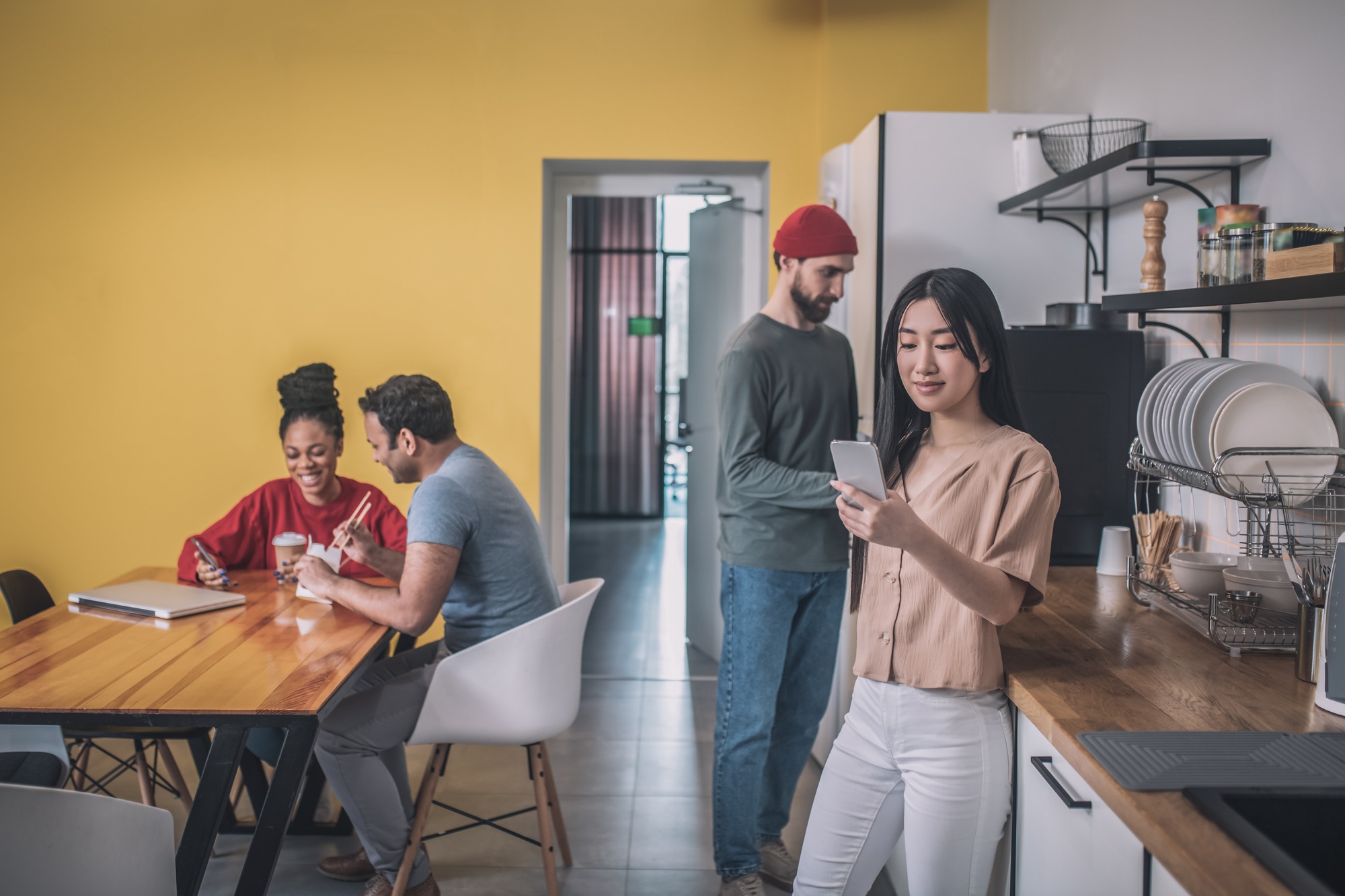 Group of young people in office kitchen